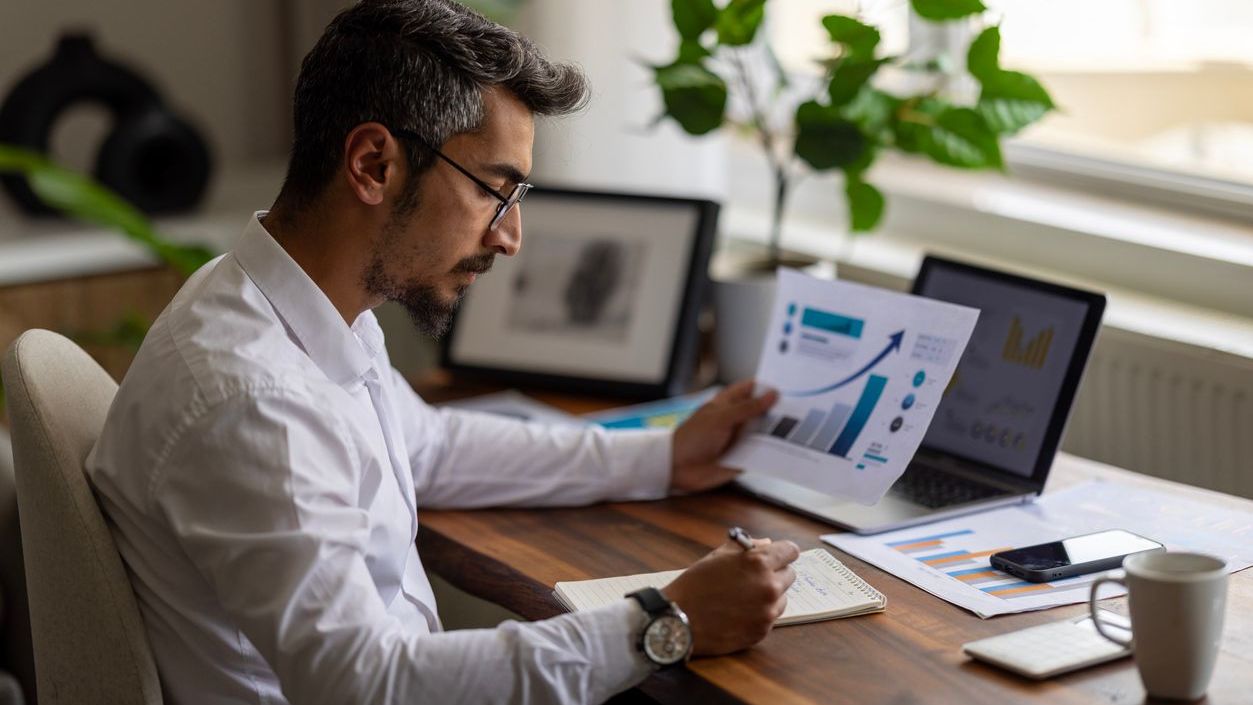 A man reviews financial reports.