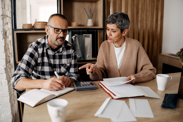 A couple calculating how much they will have to pay in a mortgage.