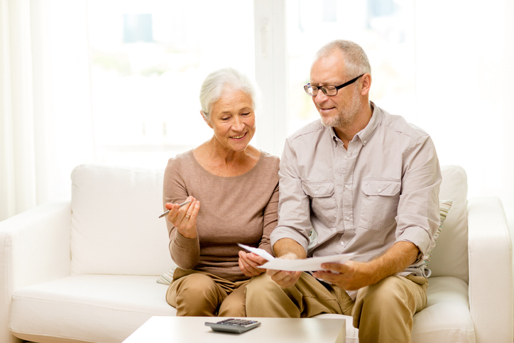 A couple reviewing documents for a living trust.