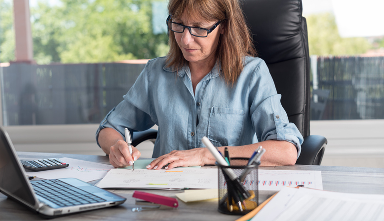 A woman preparing documents for her estate plan.