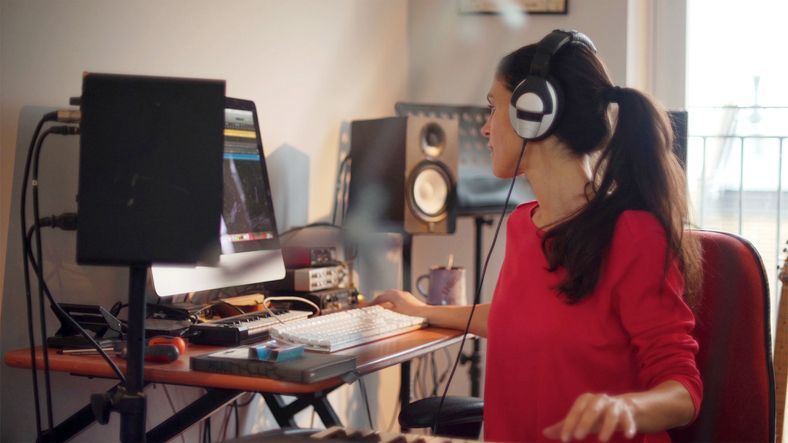 A woman composing music in her private home studio.