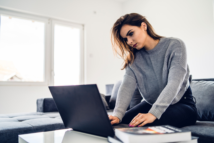 A woman calculating the residual value of an asset.