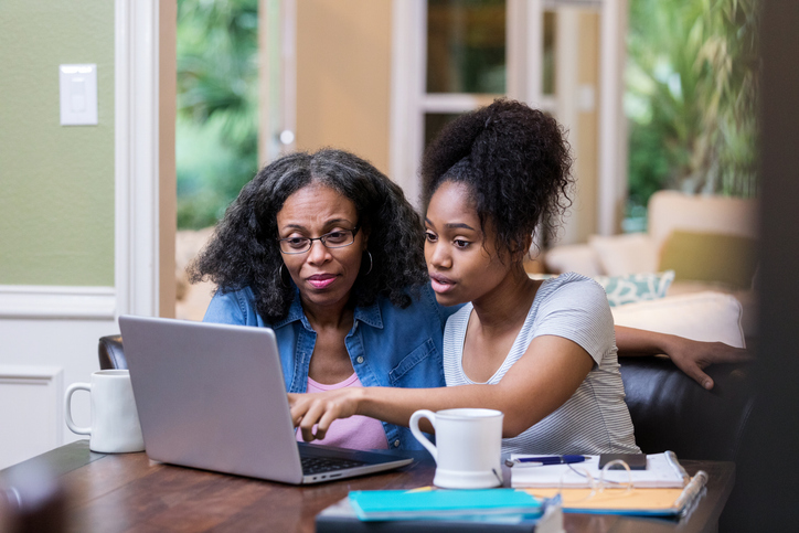 A mother and daughter researching how tax-exempt interest income could affect FAFSA.