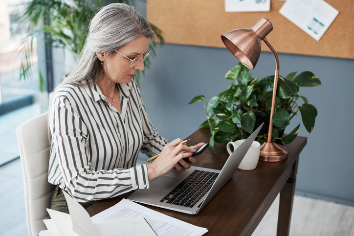 A woman reviewing documents to file taxes for investments.