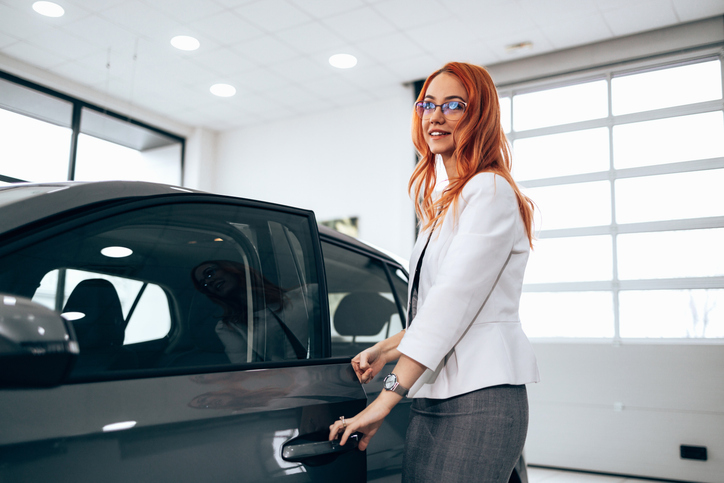 A woman testing a new car before buying it.