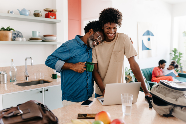 A father and his teenage son comparing different stocks.