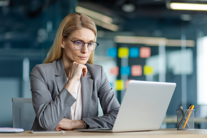 A woman rebalancing her retirement portfolio to maintain her goals.