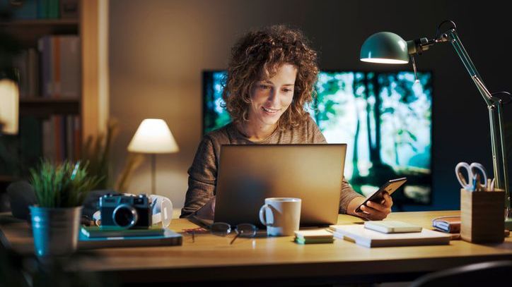 A woman sitting at the desk in her home office.