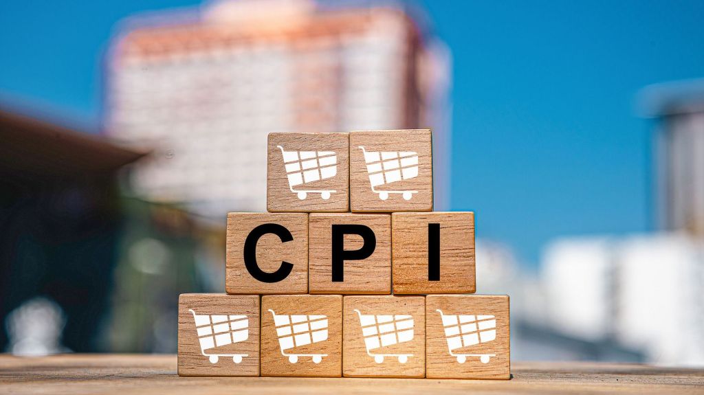 Wooden blocks with the letters "CPI" and shopping cart symbols stacked on top of each other.