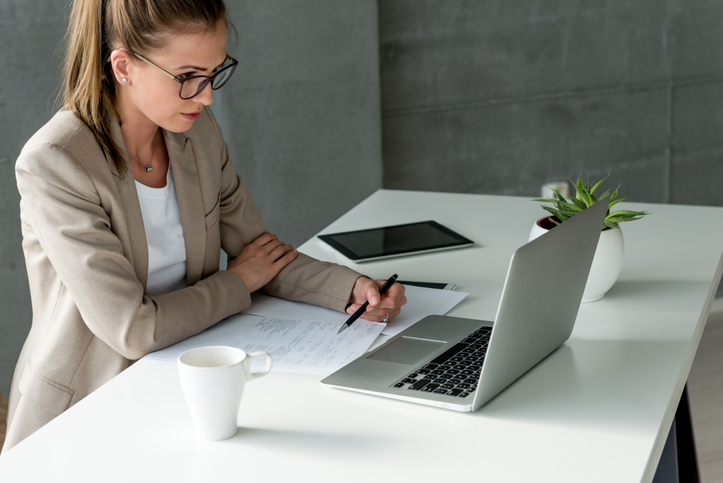 A woman reviews documents for her real estate portfolio.