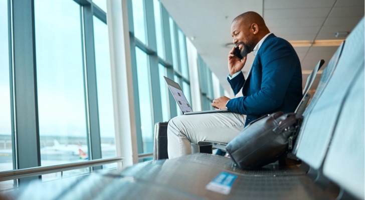 A businessman takes a phone call in an airport.