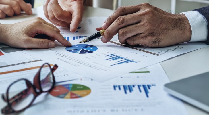 A financial advisor reviewing the performance of safe investments for a retiree.