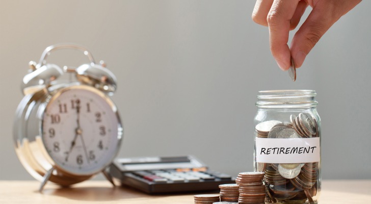Closeup of an alarm clock, a calculator and a coin jar symbolizing the importance of retirement savings.