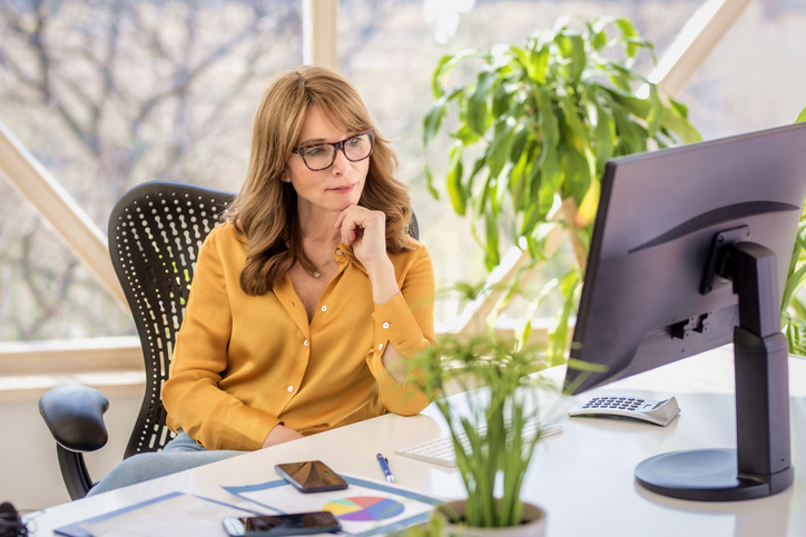 A businesswoman evaluating whether she could retire at 50 with $300,000.