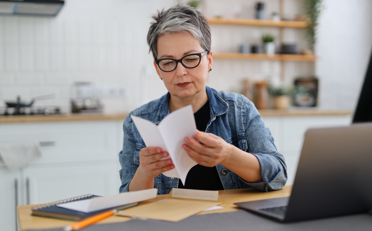 A woman reviewing documents to report tax-exempt interest.