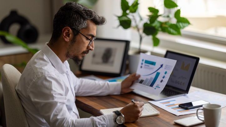 A businessman working on a financial report of corporate operations.