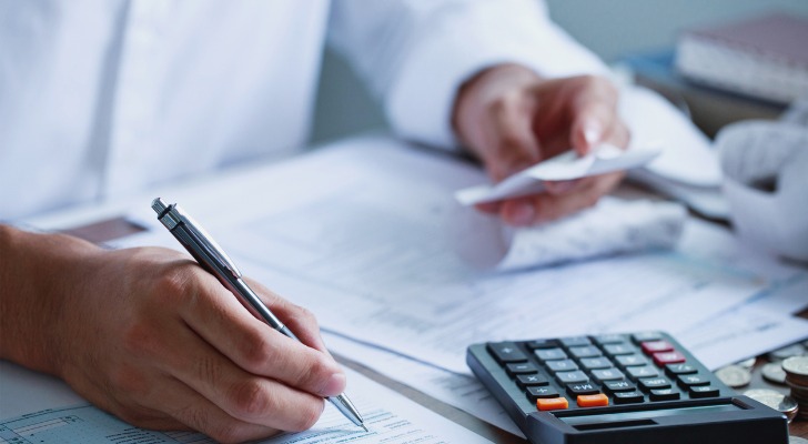 A retiree adding up expenses for his retirement budget.