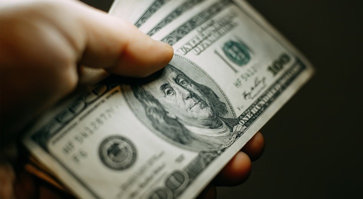 Closeup of a seller holding cash.