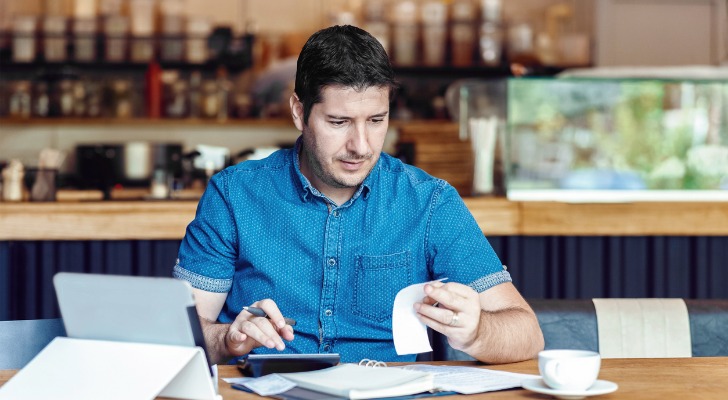 A real estate owner itemizing expenses to deduct from his taxes.