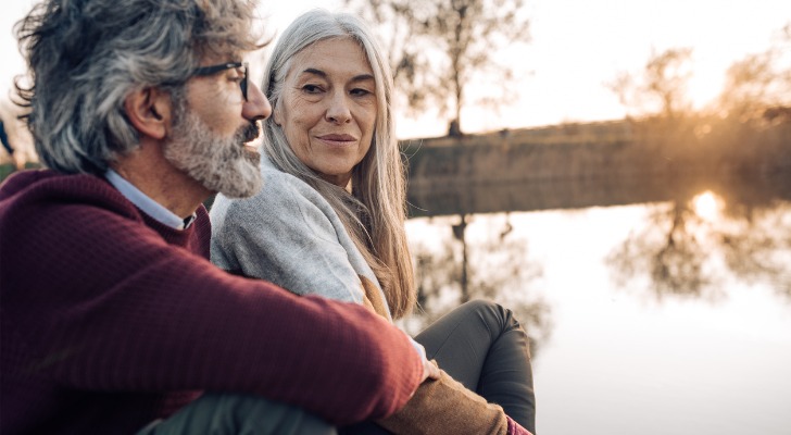 A retired couple discussing different investments for their nest egg.