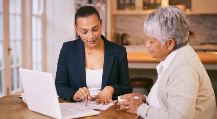 A retiree discussing her retirement portfolio with a financial advisor.