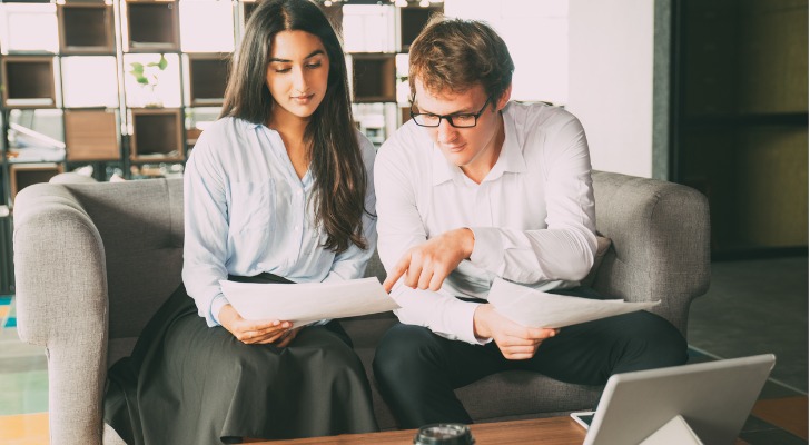 Investors discussing the pros and cons of tracking stocks.