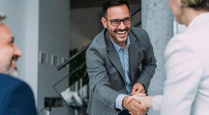 Business partners shake hands.