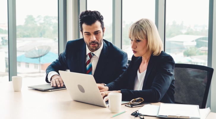 Financial advisors reviewing corporate tax strategies.