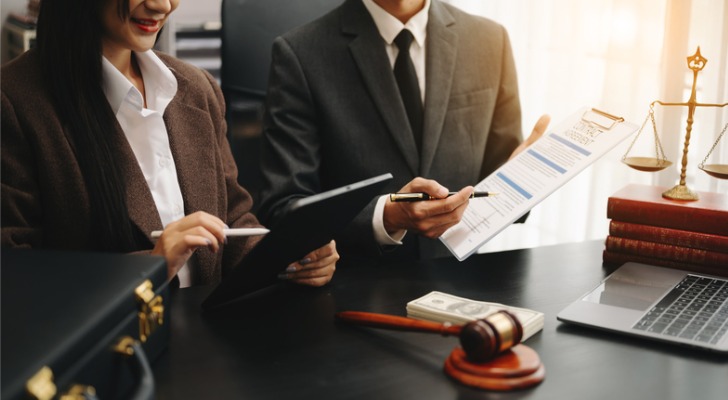Financial advisors reviewing notes from a coach.