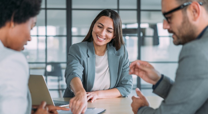 A financial advisor comparing stock investments with a Roth IRA.