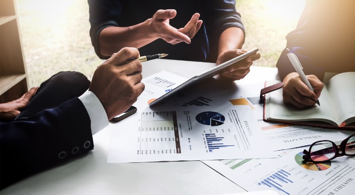 Financial advisors discussing email templates for their firm.