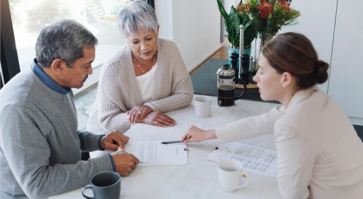 A senior couple meeting with a financial advisor to make changes to their retirement plan.