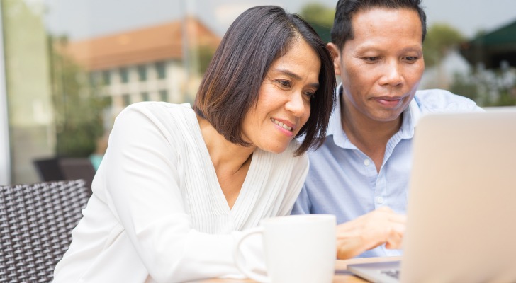 Close-up of a couple reviewing their portfolio.
