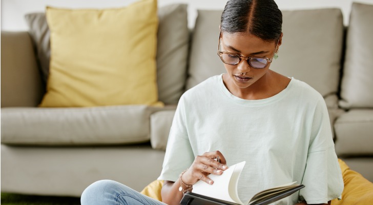 A woman researching the benefits of investing in stocks.