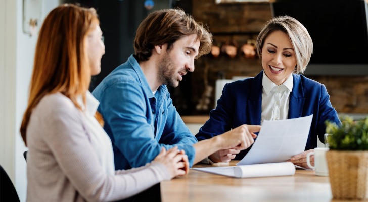 A couple meeting with a financial advisor to review their portfolio.