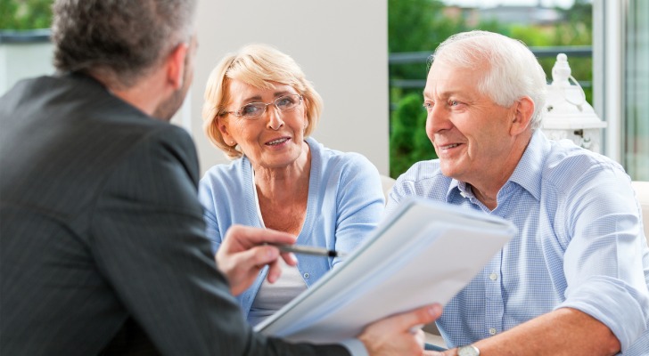 A senior couple meeting with a financial advisor to discuss their investments.