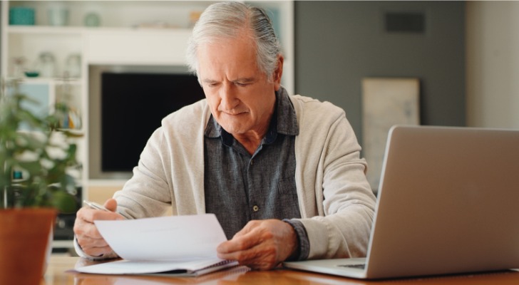 A senior reviewing documents for his retirement plan.