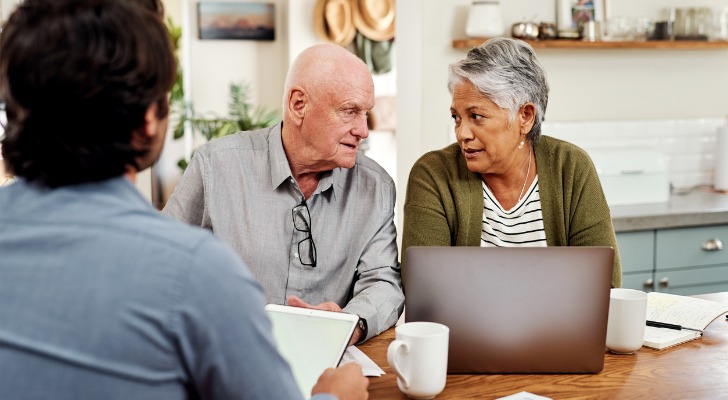 A senior couple discussing their retirement plan with a financial advisor.