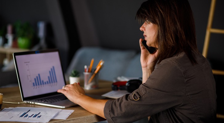 A financial advisor on the phone discussing how to build a client service agreement template for financial planning.