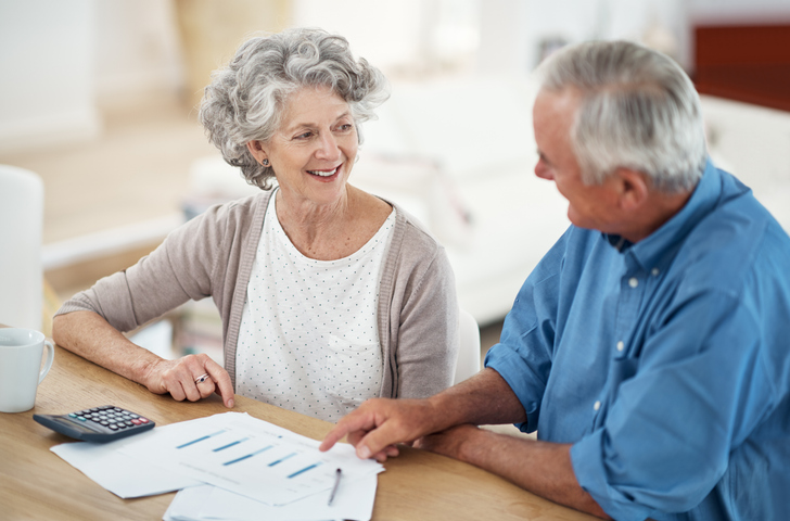 A senior couple reviewing their savings to make sure they have enough cash set aside for unexpected expenses in retirement.