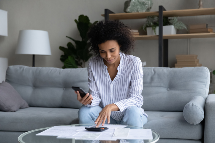 A woman calculating her student loan payments.