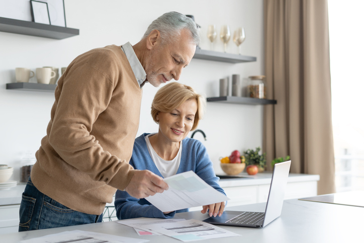 A senior couple reviewing their retirement savings.