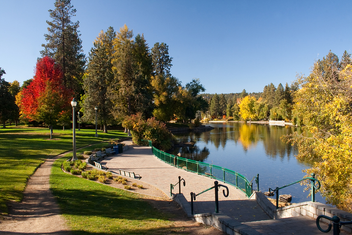 A paved pathway next to Mirror Pond in Drake Park, Bend, Oregon.