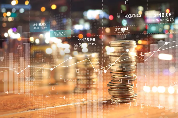 Double exposure with business charts and rows of coins for finance.