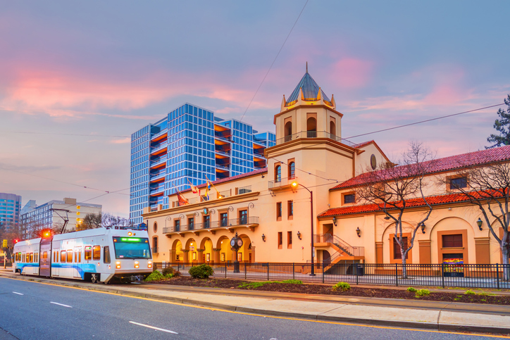 Light rail train and downtown San Jose city skyline in Silicon Valley in California, USA